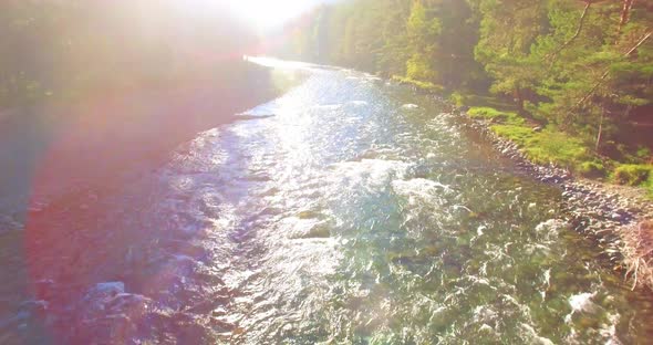 Low Altitude Flight Over Fresh Fast Mountain River with Rocks at Sunny Summer Morning