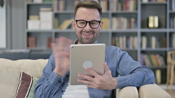 Portrait of Cheerful Young Designer Doing Video Chat on Tablet