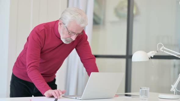 Standing Old Man Working on Laptop