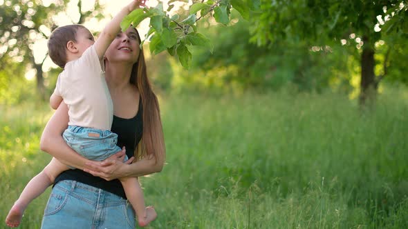 Kid and Mother are Walking in Garden