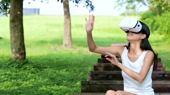 Woman watching with VR device at park
