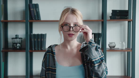 Closeup of Surprised Excited Blonde Young Woman in Checkered Shirt and Glasses Opening Her Mouth in