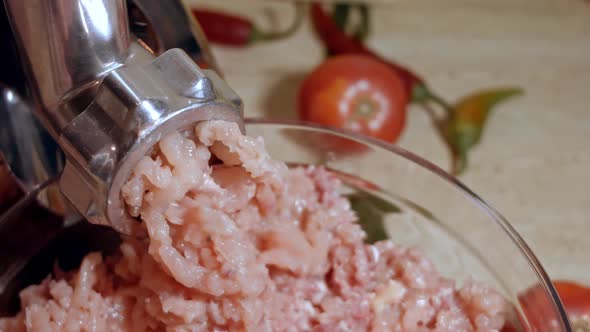 Closeup of Minced Meat is Scrolled Through a Meat Grinder Sieve