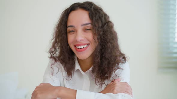 Portrait of Latino woman look at camera after wake up early from bed in bedroom in morning.