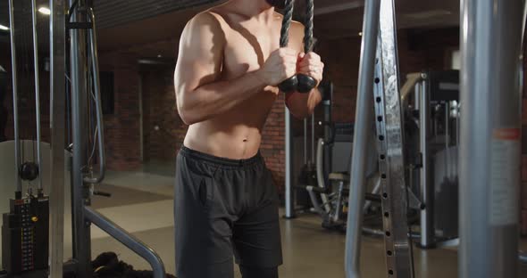 Muscular Shirtless Man Covered Sweat is Training His Arm and Back Heavy Weight