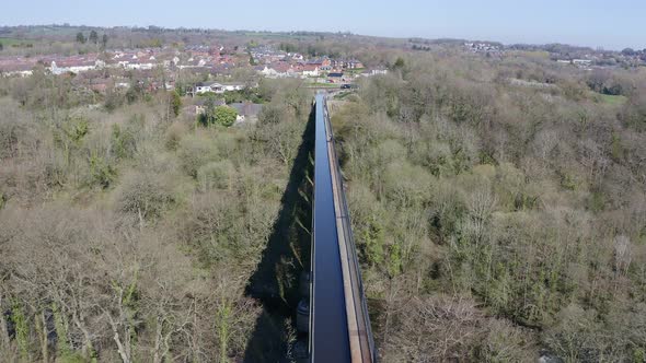 A cyclist walking across the beautiful narrow Boat canal route called the Pontcysyllte Aqueduct famo