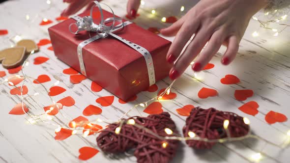 Female Hand Taking a Gift Box From the Desk, Close Up