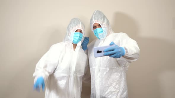 doctors in ppe taking a selfie with the mobile phone