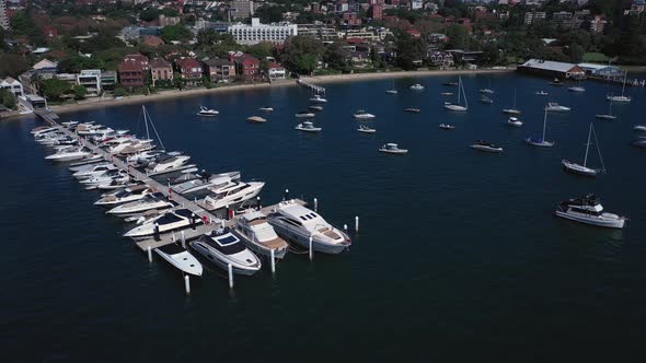 Sydney Harbor on a beautiful sunny day from Double Bay featuring boats, blue sky and water. Drone or