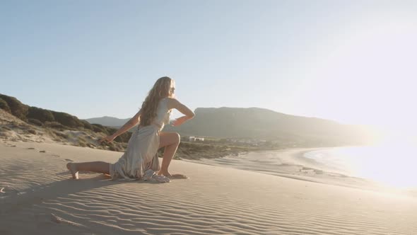 Beautiful Woman Dancing In Gold On Beach