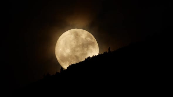 Moon and Clouds at Night Sky Over Mountain Forest Mystical and Mystery Huge Moon Nature Timelapse