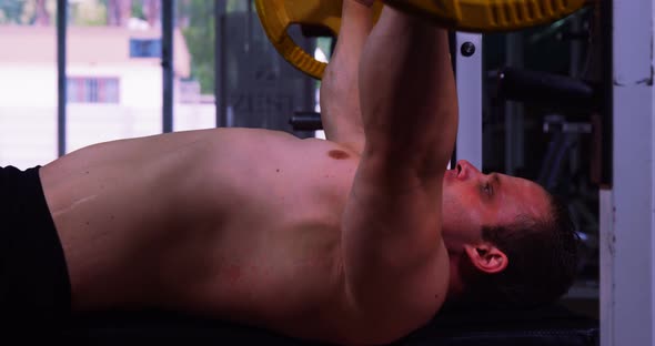 Muscular man lifting barbell