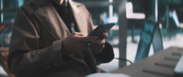 Young woman using smartphone and smiling