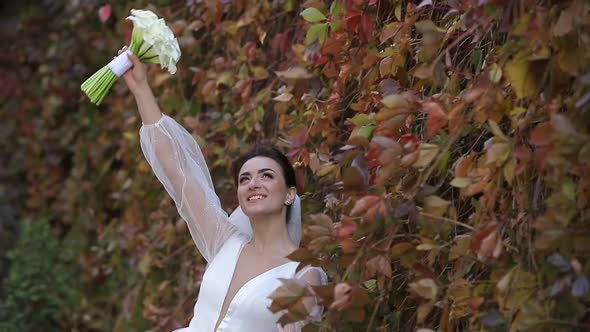 Beautiful Smiling Bride on the Background of Autumn Park