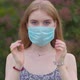 Beautiful young blonde girl takes off a medical mask - VideoHive Item for Sale