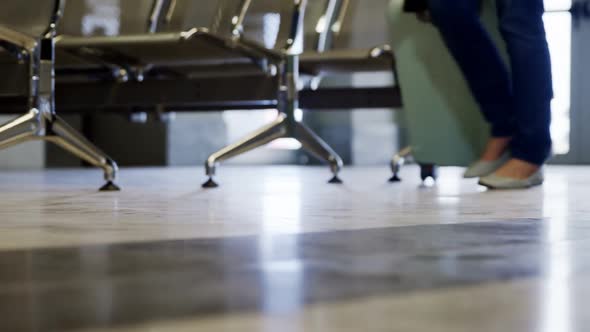 Passengers walking with their luggage at airport