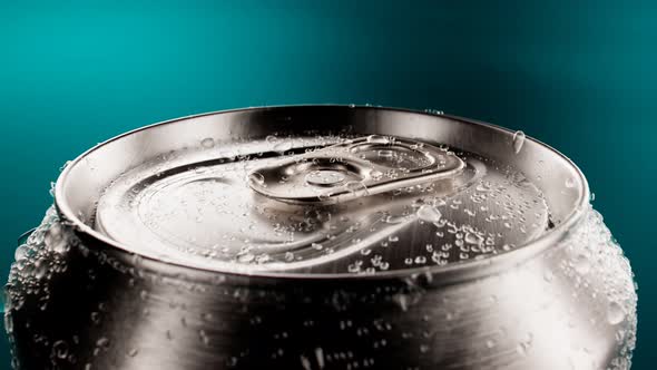 Opening up a  flip-top can of soda. Cool canned drink with droplets. Refreshment