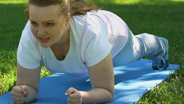 Plump Girl Doing Plank Outdoor, Endurance and Strength, Healthy Lifestyle