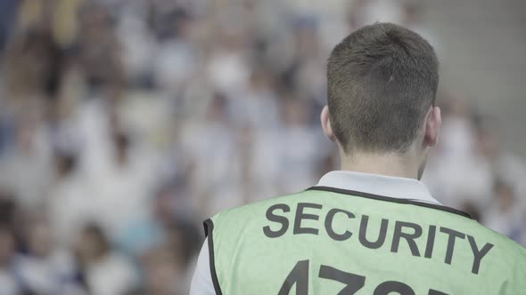 Male Security Guard in a Stadium During a Football Soccer Match.