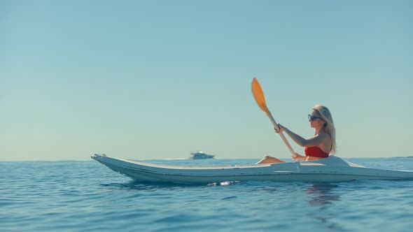 Girl In Kayak Summer Trip. Woman Exploring Calm Sea By Canoe On Holiday Vacation Weekend.