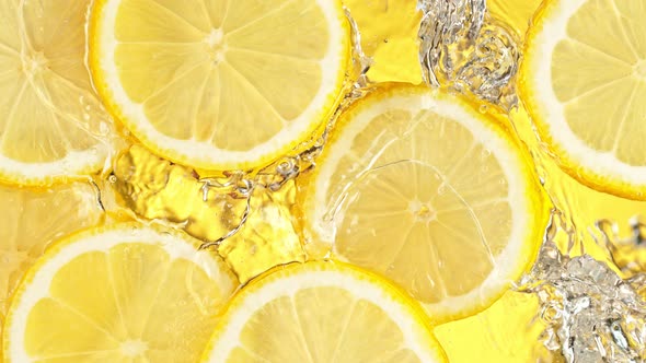 Super Slow Motion Shot of Splashing Fresh Lemon Slices Into Water at 1000 Fps