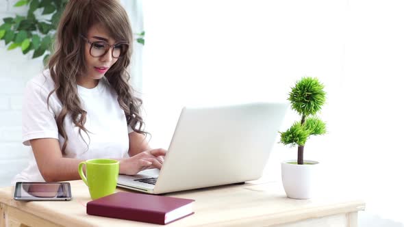 Young Woman Typing on a Laptop 02