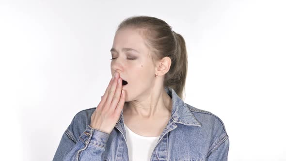 Casual Young Woman Yawning on White Background