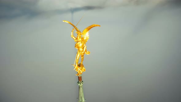 Extreme Aerial Close-up Shot of Heavenly Golden Saint Michael Angel Statue on Mont Saint Michel Sky