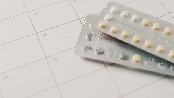 Video of close up of yellow tablets over white calendar