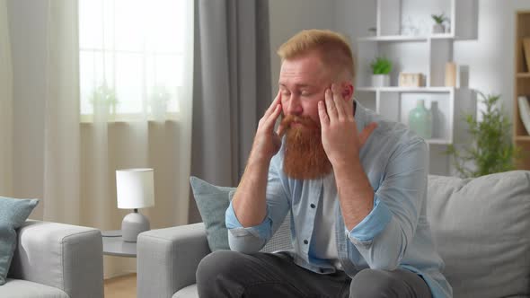 Disappointed Redhead Bearded Man Sit on Sofa Thinks Looks Sad Frustrated Deeply Unhappy Feels Moral