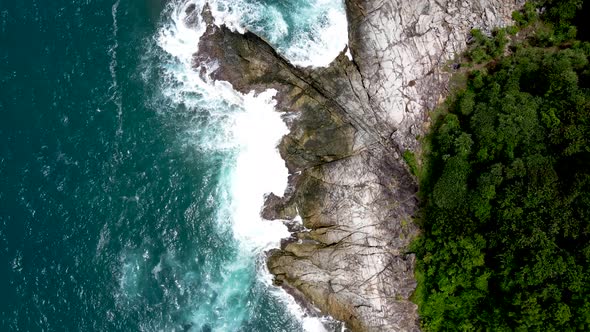 Aerial Birds Eye View Over Waves Breaking On Coastline Rocks In Phuket. Dolly Forward