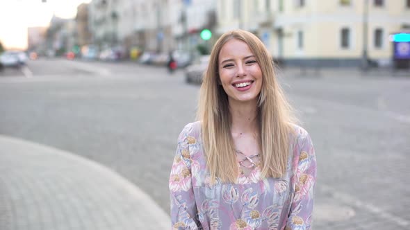 Portrait of Beautiful Smiling Woman 20s Wearing Dress Laughing While Walking in Urban Area with Road