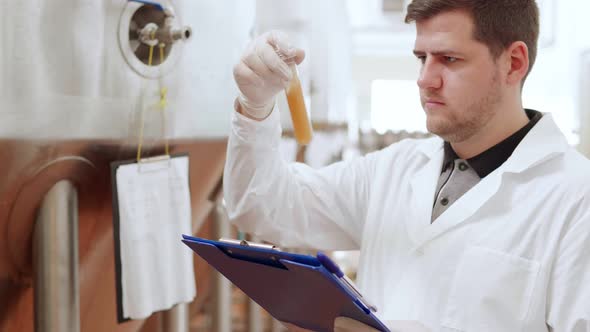 A Technologist at a Brewery Performs Quality Control