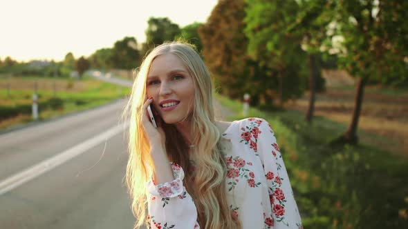 Woman Making Video Call Near Countryside Road.