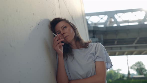 Female Portrait on the Background of a Railway Bridge