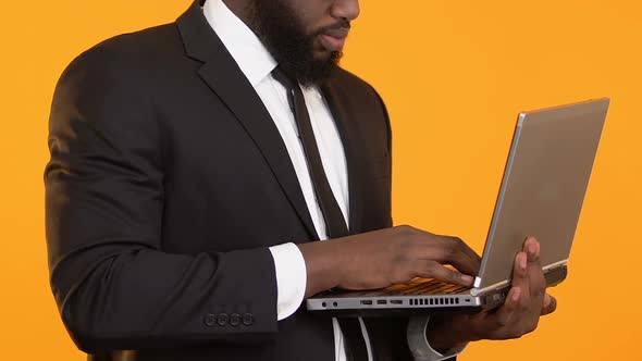 Smart African-American Manager Holding Laptop, Working on Business Project
