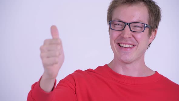 Face of Happy Young Handsome Man Giving Thumbs Up