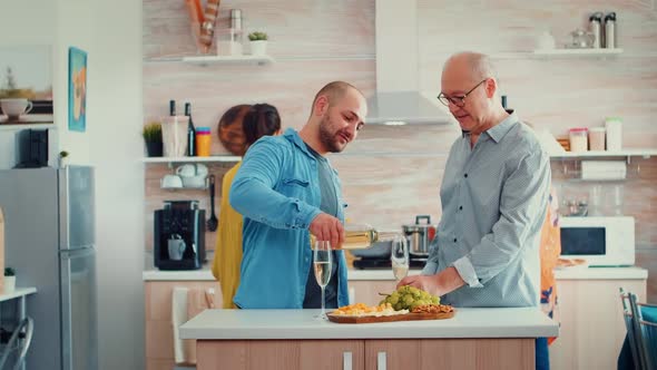 Son Pouring Wine in Father's Glass