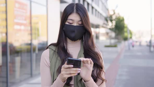 Young Asian Woman Face Mask Works Smartphone Street Urban Area