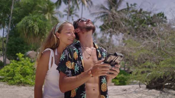 A Close Up Shot of an Active Man and Woman Couple Flying a Drone Outdoors