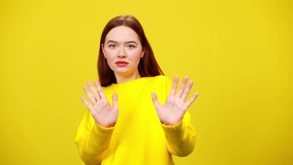 Scared Young Caucasian Redhead Woman Stretching Hands Moving Away From Camera in Slow Motion