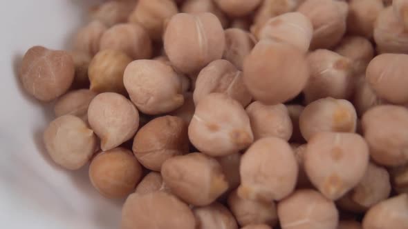 Turkish pea beans fall in a pile in a white plate 