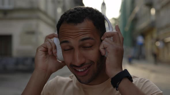 Smiled African American Male Runner Wearing the Headphones