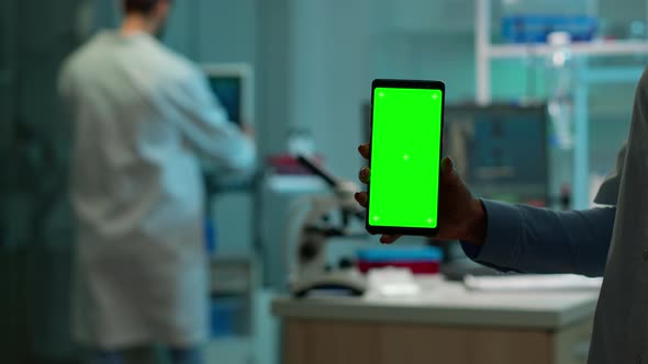 Close Up of Chemist's Hand Holding Phone with Green Screen