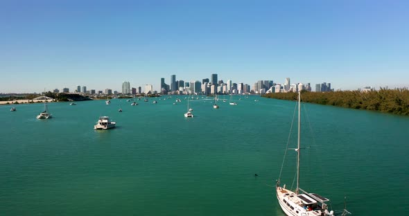 4K aerial of Miami bay with downtown Miami in background. Drone flying over yachts in Miami 