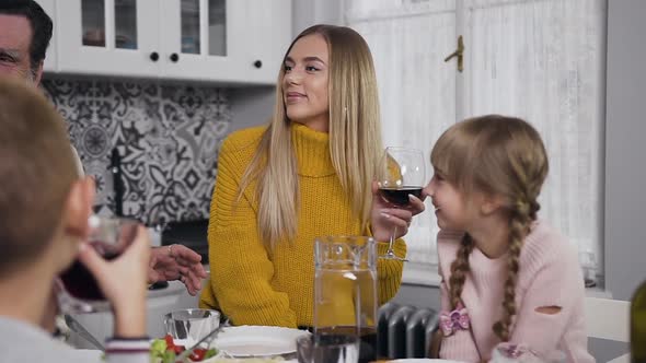 Pretty Young Woman in Yellow Knitted Sweater Listening the Story that Telling Old Respected Man