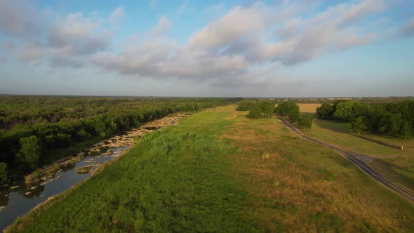 Aerial footage of the Pedernales River near Stonewall Texas. Camera is heading west along the river.