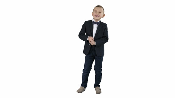 Little boy in formal outfit talking and smiling on white