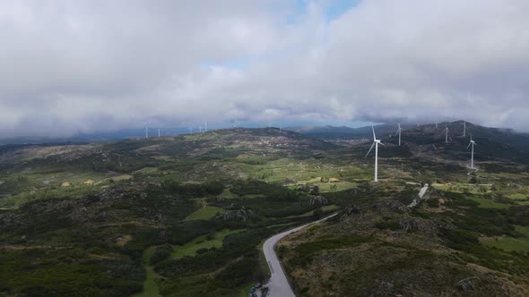 One person on Caramulinho viewpoint and eolic wind turbines in background. Caramulo in Portugal. Aer