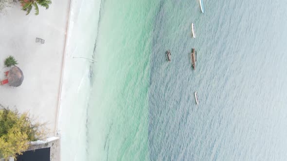 Vertical Video Boats in the Ocean Near the Coast of Zanzibar Tanzania Aerial View